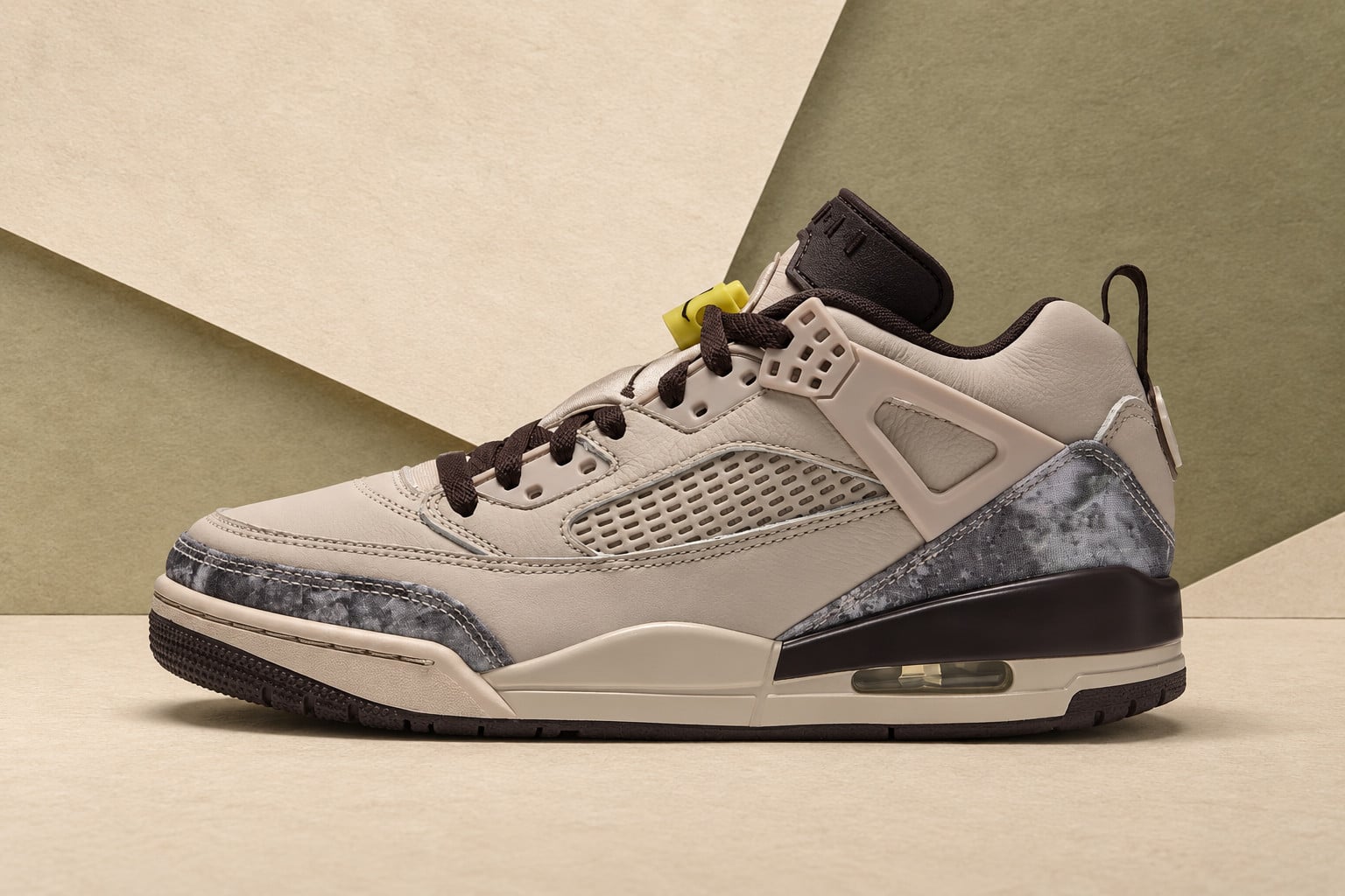 Lateral view on olive and cream paper backdrop, tan leather with grey camo overlays, Jordan Spiz’ike Low “Realtree Camo”