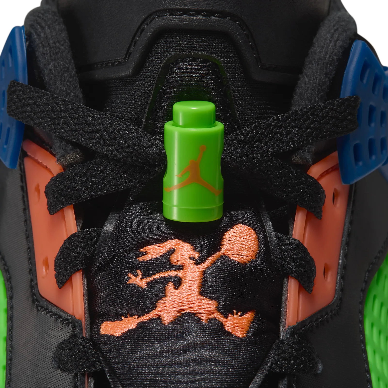 Close-up of green lace lock with orange Jumpman logo above orange embroidered Jumpman on black tongue, Space Jam
