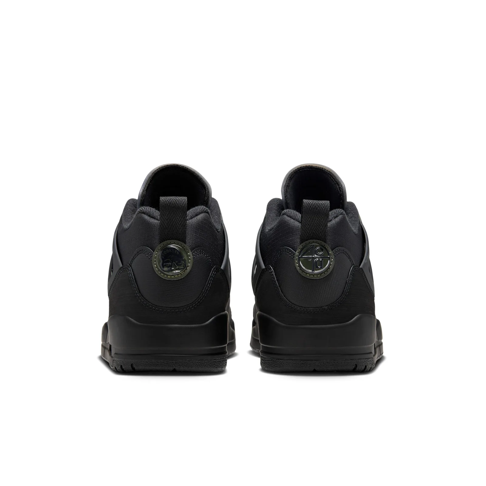 Heel view of pair, black pull tabs and round olive-rimmed heel badges with embossed designs, Black