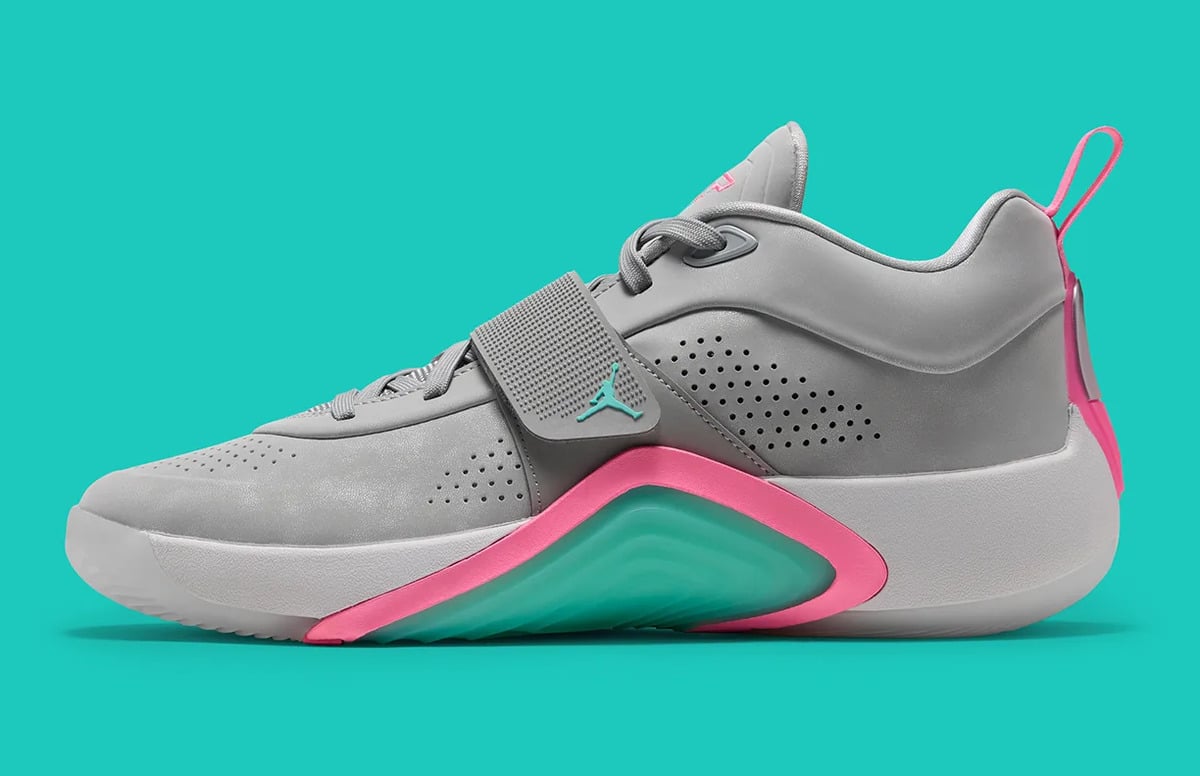 Lateral side view, grey leather upper, teal Jumpman on strap, pink-trimmed teal heel unit, South Beach