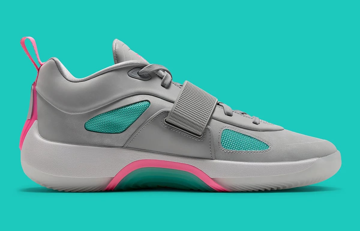 Medial view of grey sneaker with teal mesh panels, hook-and-loop strap and pink heel loop, South Beach