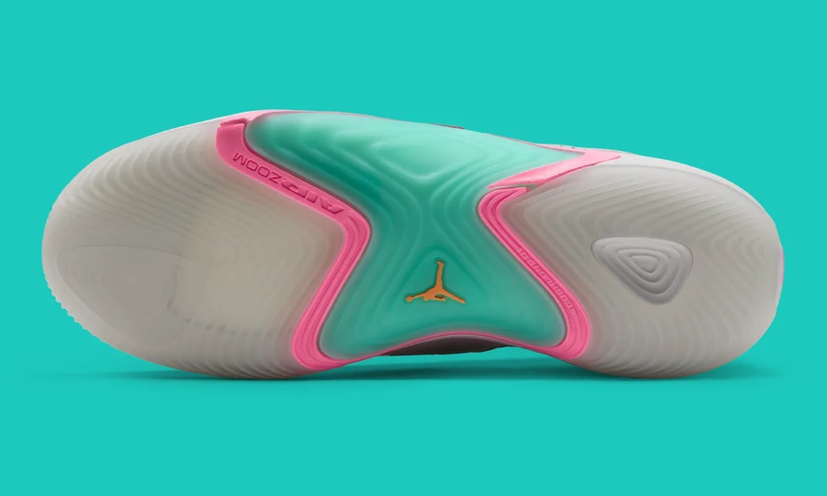 Outsole view, translucent pale tread, teal centre, pink trim, Air Zoom text, orange Jumpman, South Beach