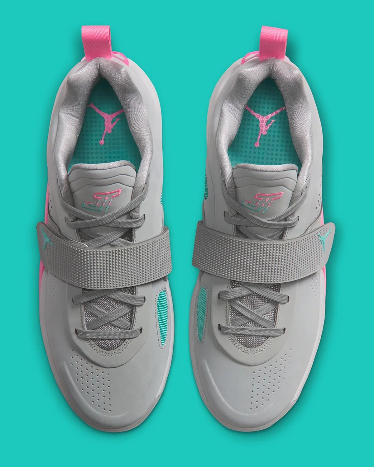 Top-down view of pair, grey straps, teal insoles with pink Jumpman, JT logo on tongues, South Beach