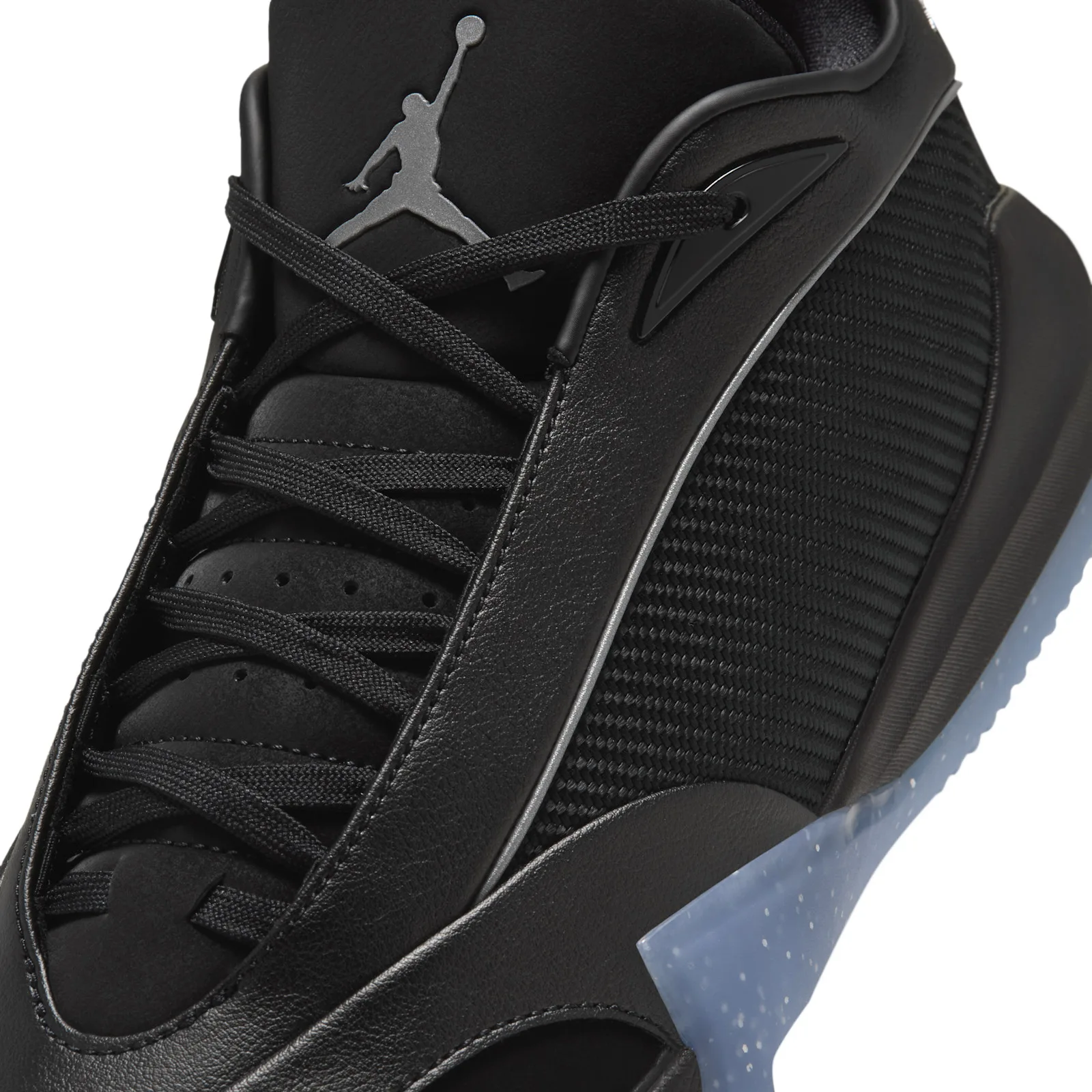 Detail of the laces and midfoot, black leather overlays, woven mesh, grey Jumpman on the tongue, blue sole edge
