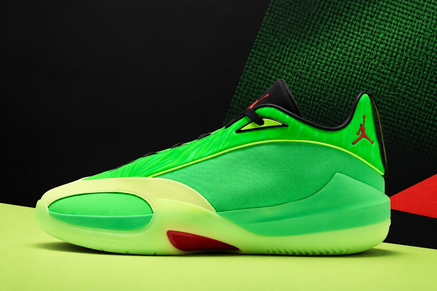 Lateral studio shot on black and green backdrop, bright green upper, pale lime sole, Jordan Triangle “Paolo Banchero” PE