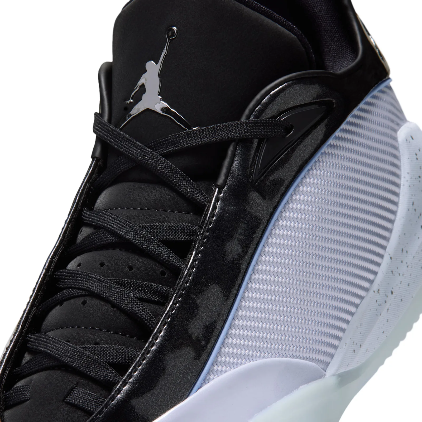Detail of lacing, black laces, chrome Jumpman on tongue, white woven panel with speckles, Space Jam