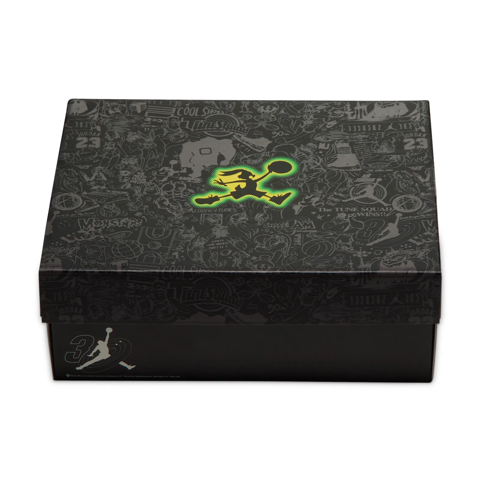 Packaging, black shoebox lid with grey cartoon print and glowing green-yellow Jumpman graphic, Space Jam