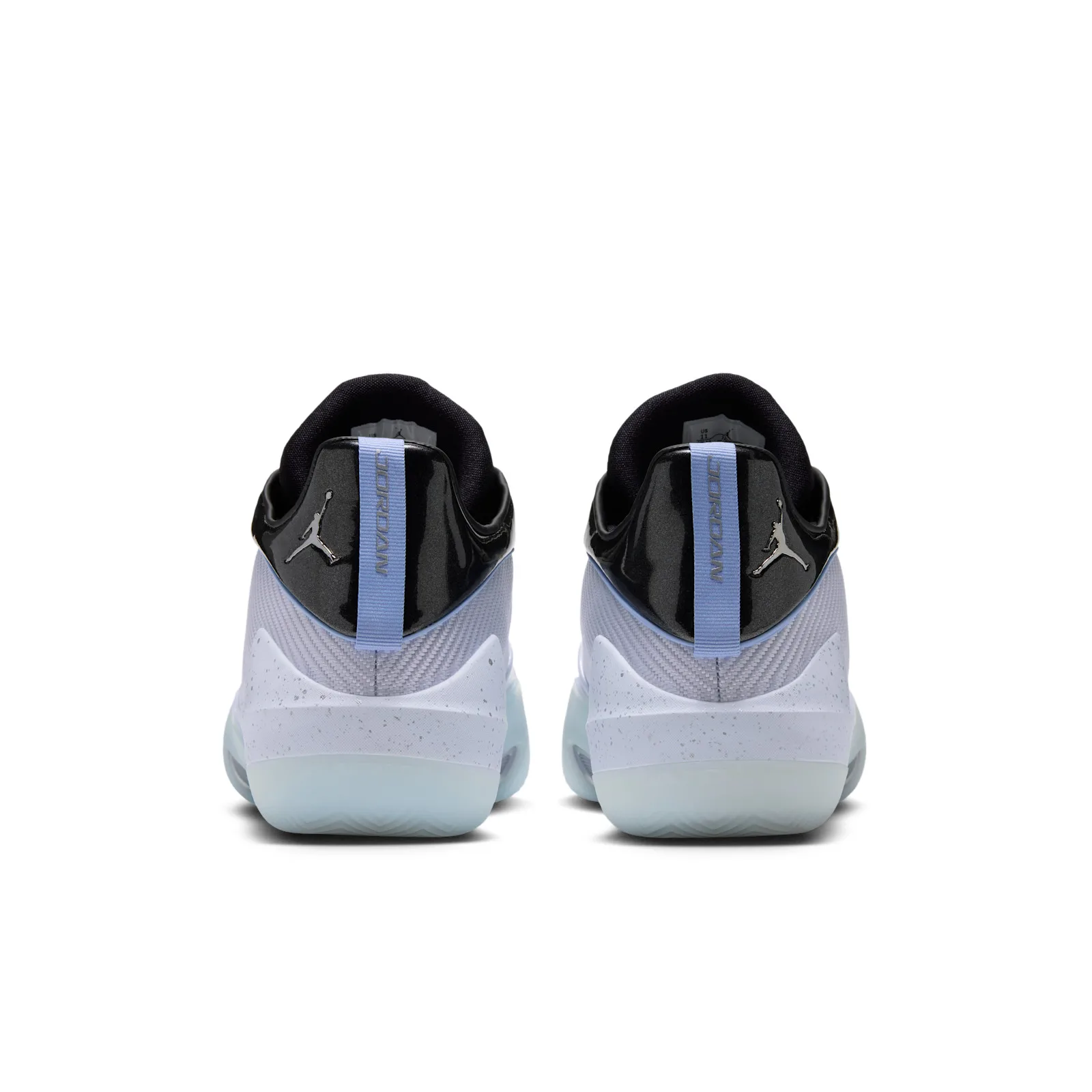 Heel view of the pair, light blue pull tabs with vertical Jordan text, silver Jumpman logos, Space Jam