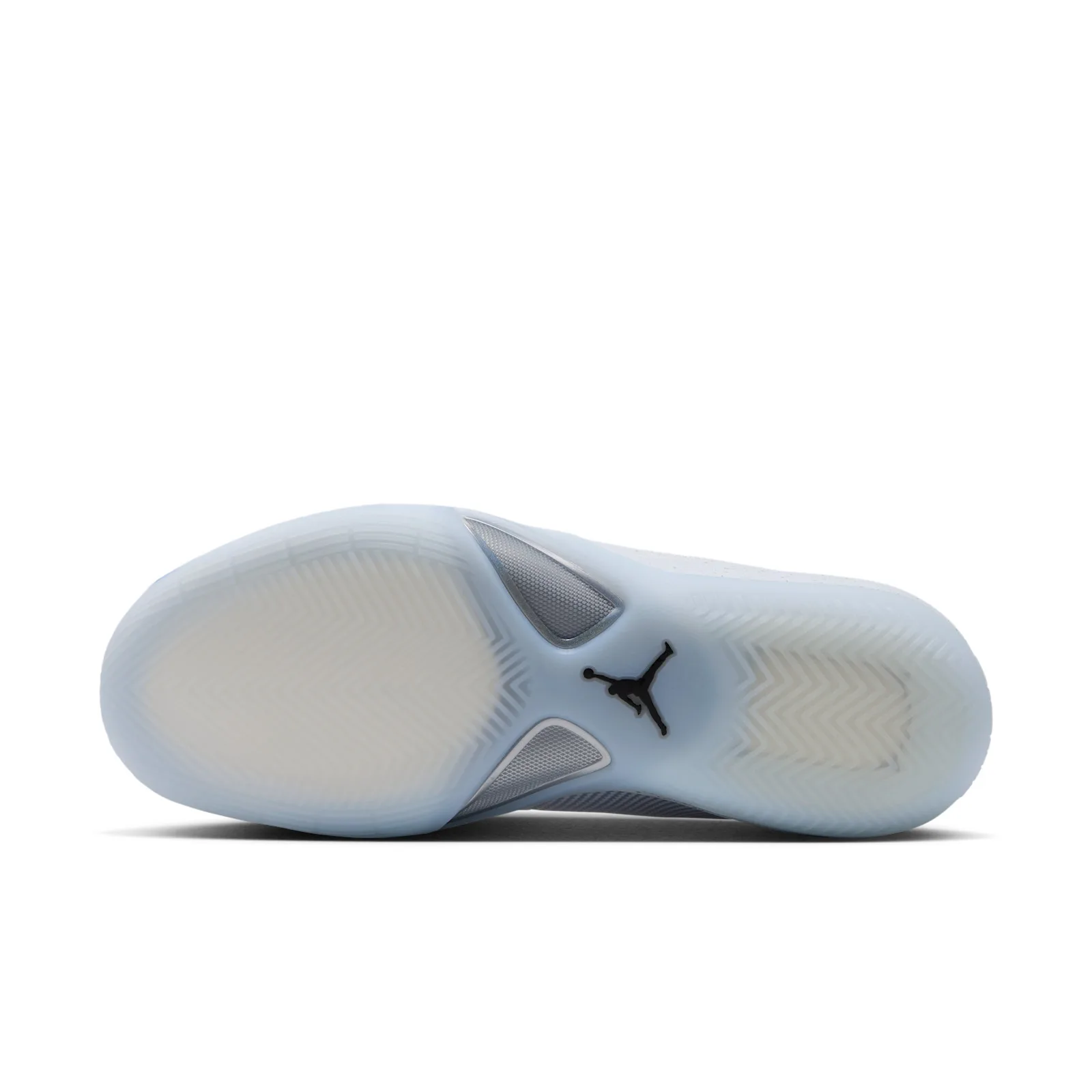 Outsole view, icy translucent sole with chevron pattern, black Jumpman logo at the center, Space Jam