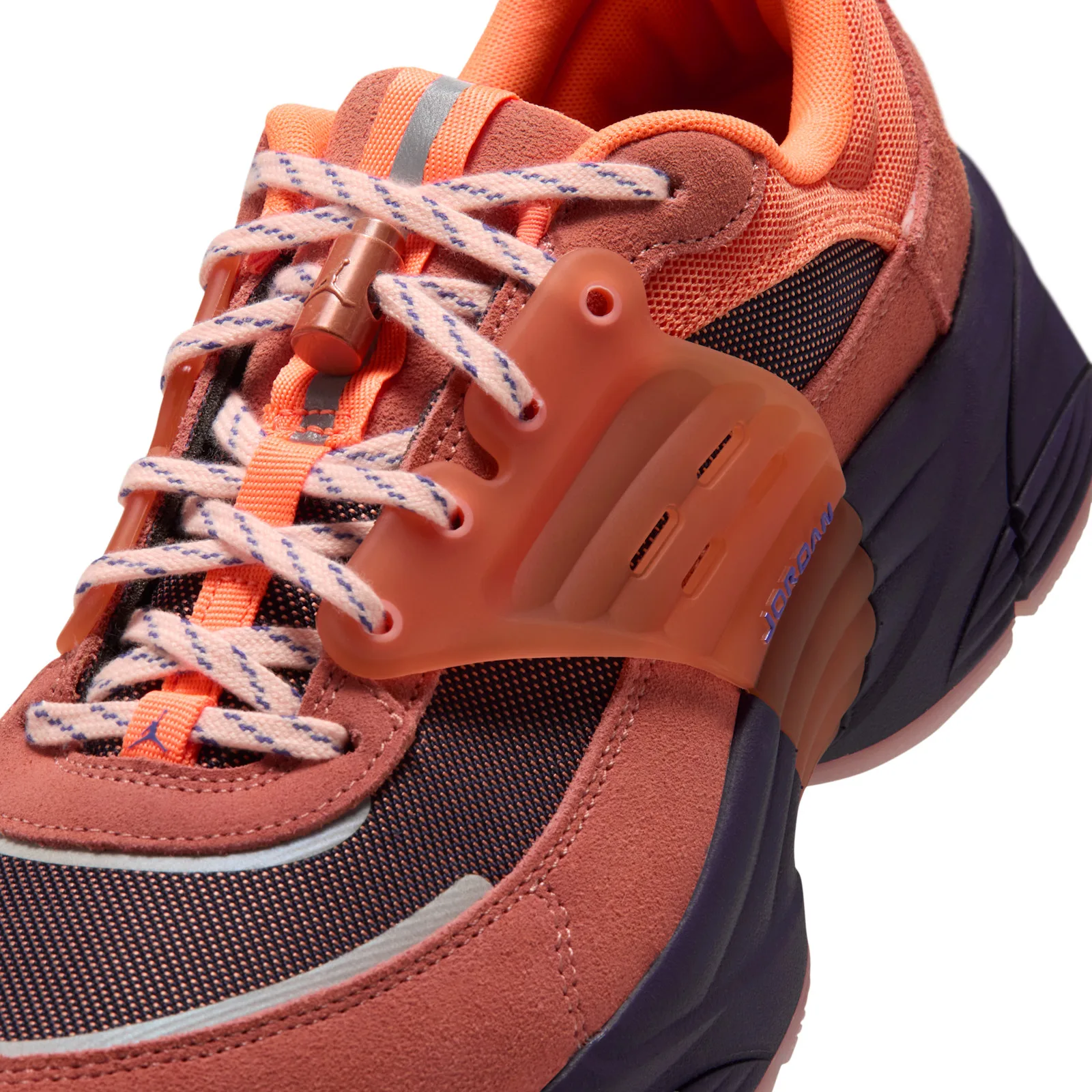 Detail of laces and strap, cream laces with blue flecks, copper toggle, translucent orange strap with Jordan text, Space Jam
