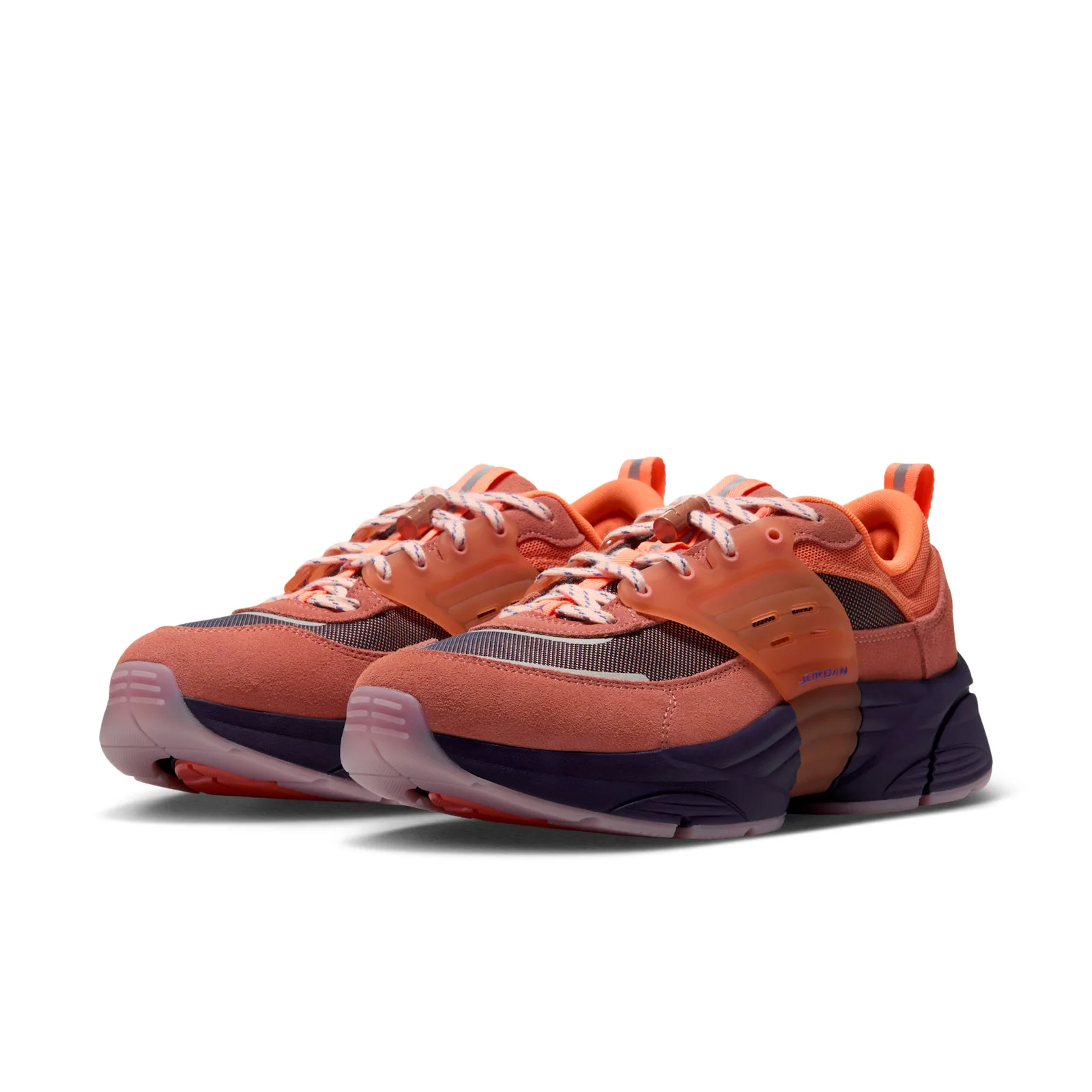 Pair at three-quarter angle, coral suede, translucent orange straps, cream laces with blue flecks, purple midsoles, Space