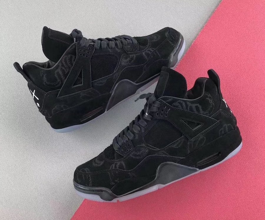 Pair of black suede sneakers on grey and pink backdrop, white XX logo on heel, icy soles, Dark Grey