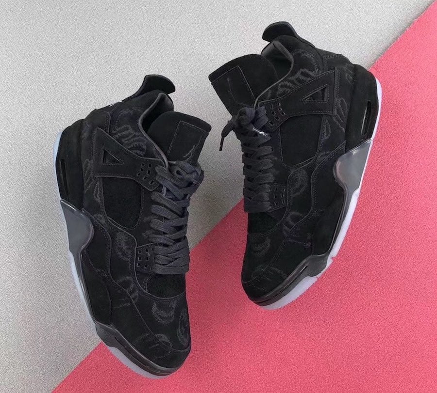 Top-down pair of black suede sneakers with faint pattern and icy translucent soles on grey and pink, Dark Grey