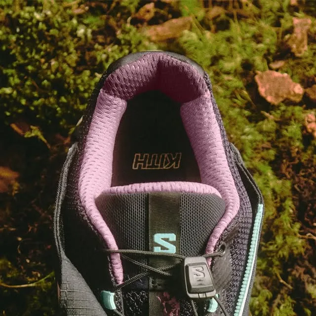 Detail of purple mesh collar and tongue with Kith text and mint S logo, on moss, Winter 2026 Collection