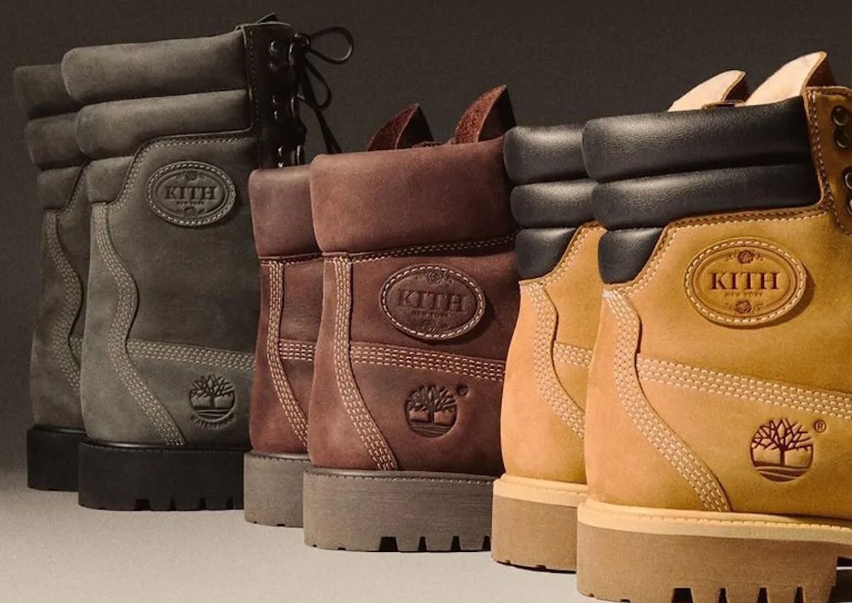 Close heel view of three boots in grey, brown and wheat with Kith oval badges, Wheat