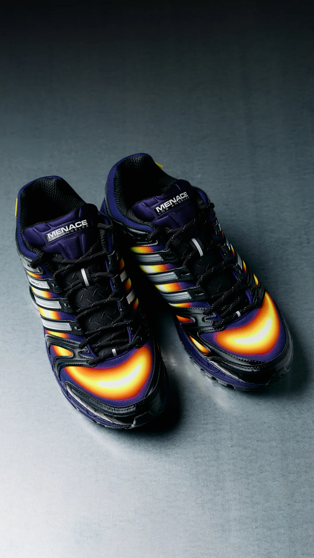 Top-down view of both tongues with MENACE Los Angeles labels over black laces and the thermal-print toe caps