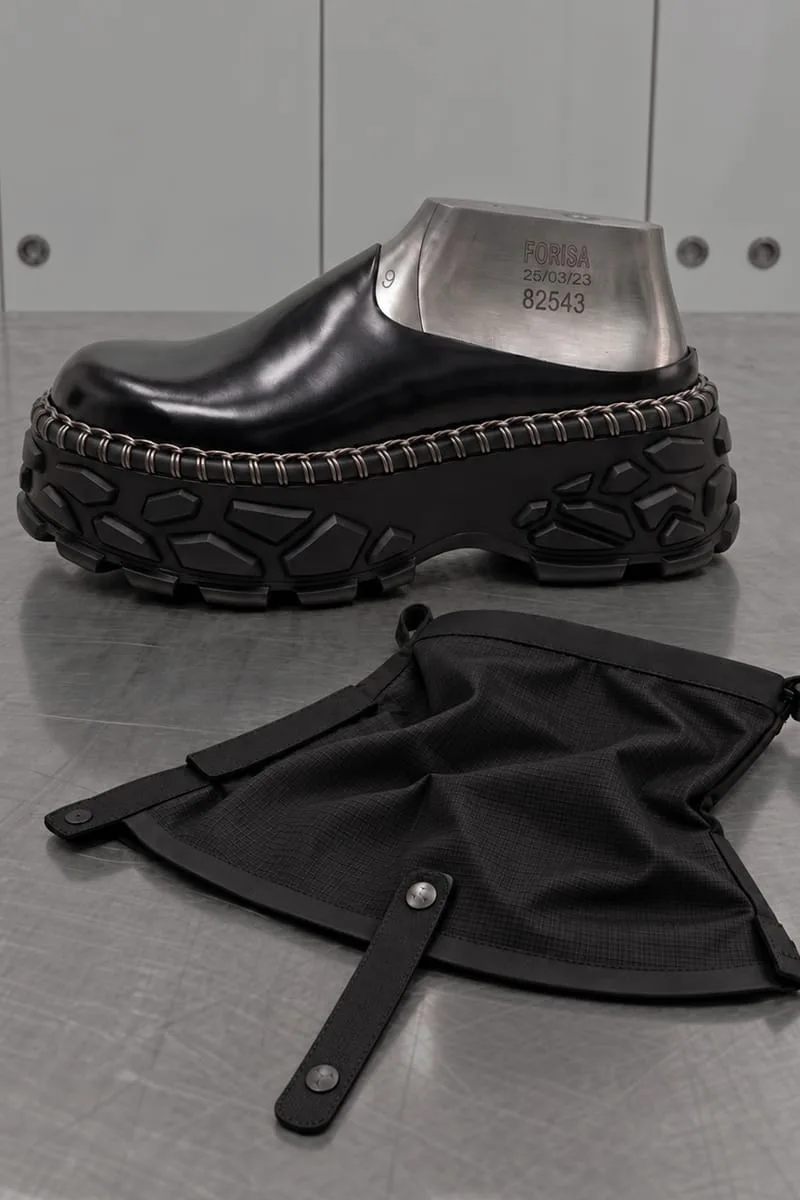 lateral view on a steel shoe last next to a black ripstop dust bag, Terracotta