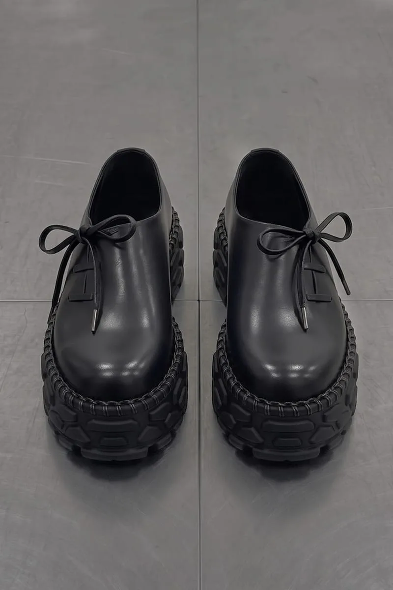top-down pair view on tiled floor, bow-tied laces, chunky lugged soles, Terracotta