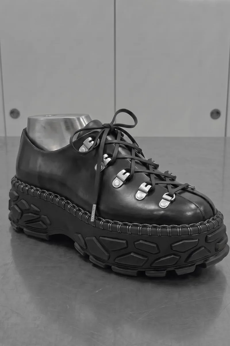 three-quarter view on steel last, hiking-style lace hooks, lugged sole, Terracotta