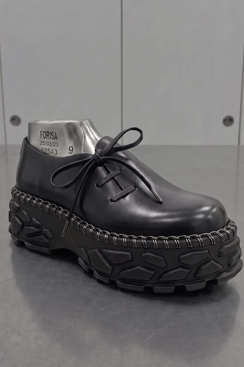 three-quarter view on steel last, plain toe, bow-tied laces, lugged sole, Terracotta