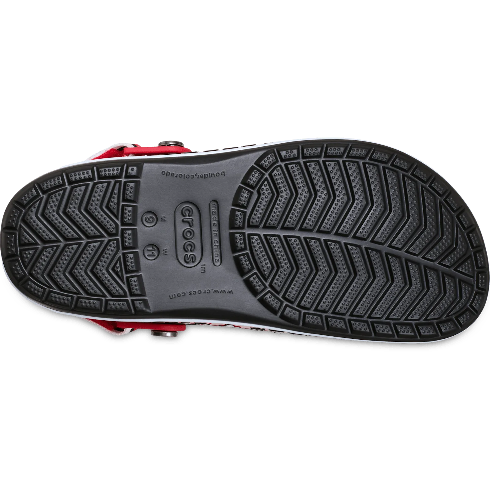 Outsole of black clog with chevron tread and crocs logo, red strap at heel, Crocband Clog Collection