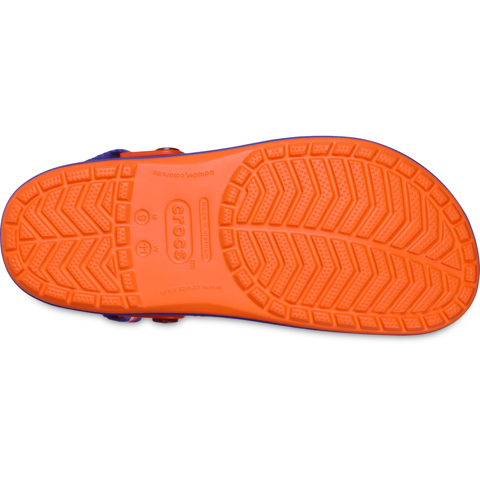 Outsole of orange clog with chevron tread, blue edge and crocs logo at centre, Crocband Clog Collection