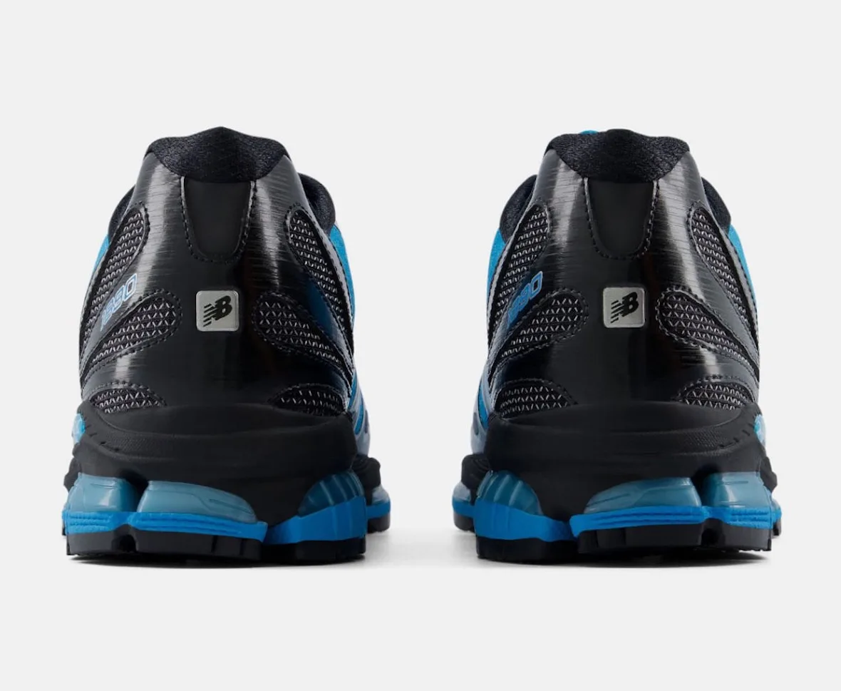 heel view of pair, black counters with silver New Balance tags and blue soles, Blue/Silver/Black