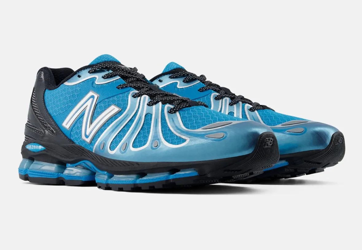 pair shown at angle, blue uppers with silver N logos and black heel counters, Blue/Silver/Black