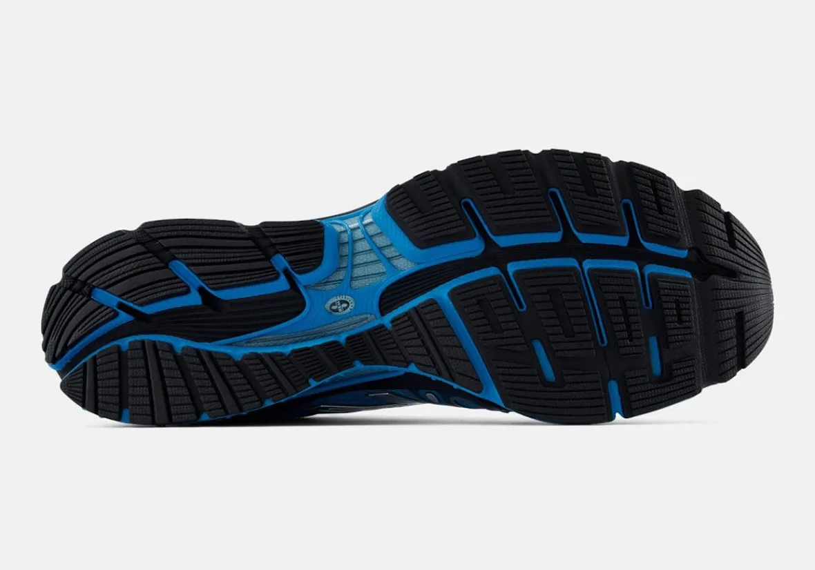outsole close-up, black tread with blue accents and New Balance logo, Blue/Silver/Black