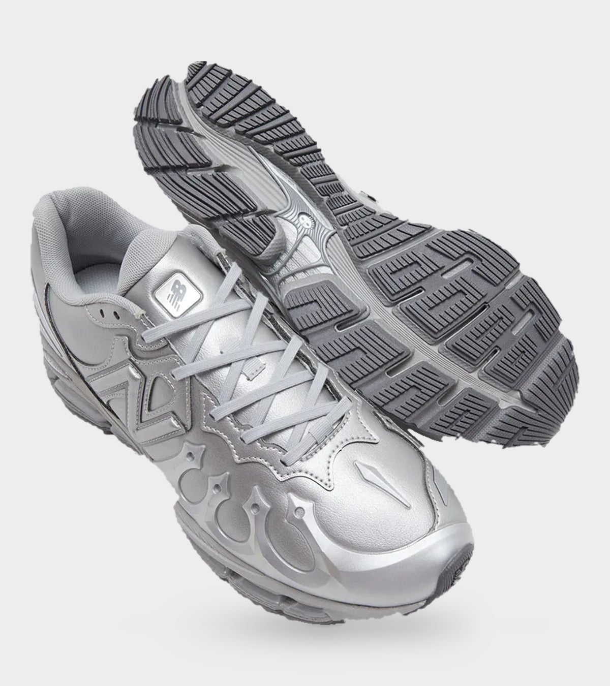 Pair with one shoe upright and one showing the dark grey outsole with chunky lug pattern, Liquid Metal