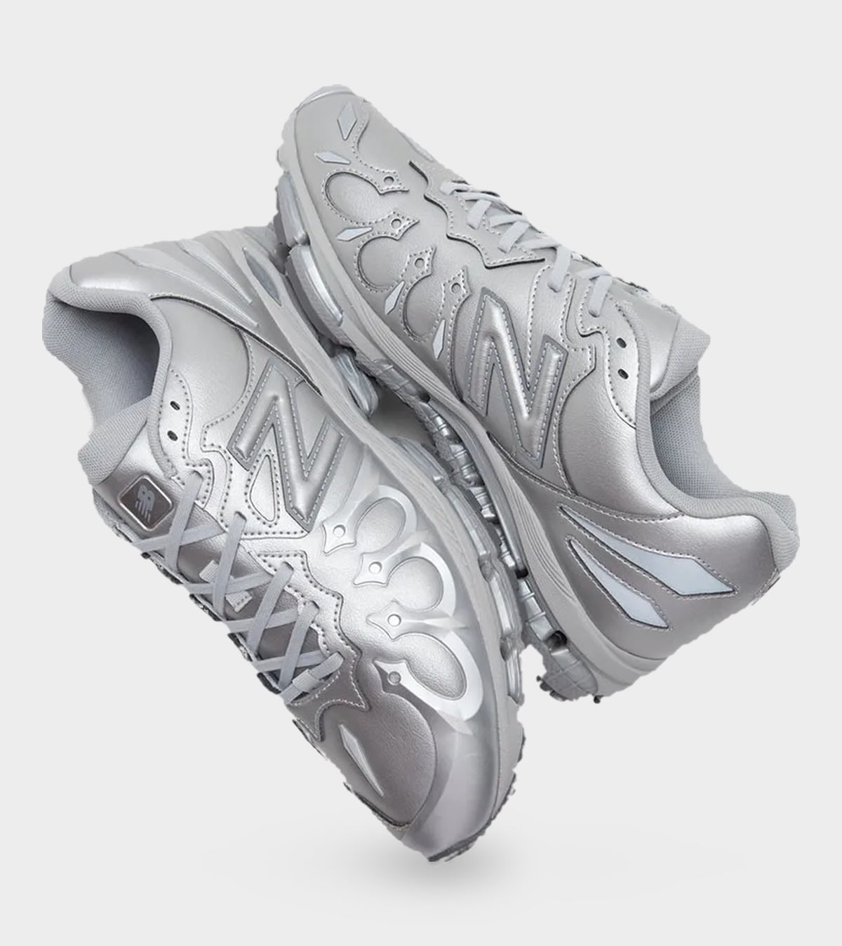 Top-down pair in metallic silver, with flame-like toe overlays, N logos and grey laces, Liquid Metal