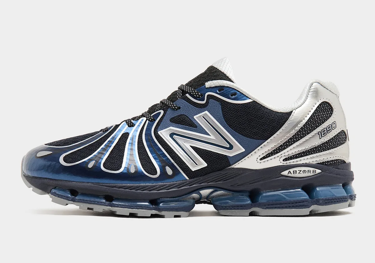 Lateral view on plain white, glossy blue toe overlays, silver heel with 1890 text and ABZORB badge, Metallic Blue