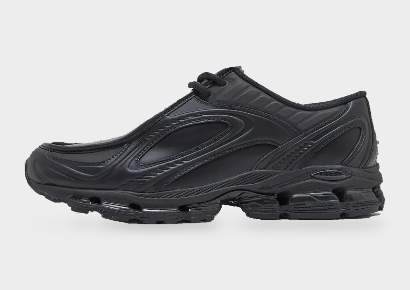 Lateral view of all-black leather shoe with sculpted overlays and chunky lugged sole, New Balance 1890A “Black Leather”