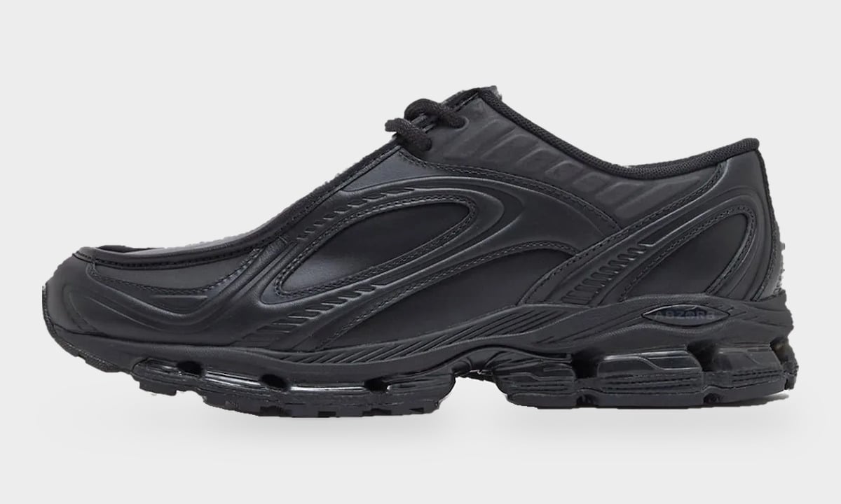 Lateral view of all-black shoe with layered black overlays and visible cushioning pods in the midsole, Black Leather