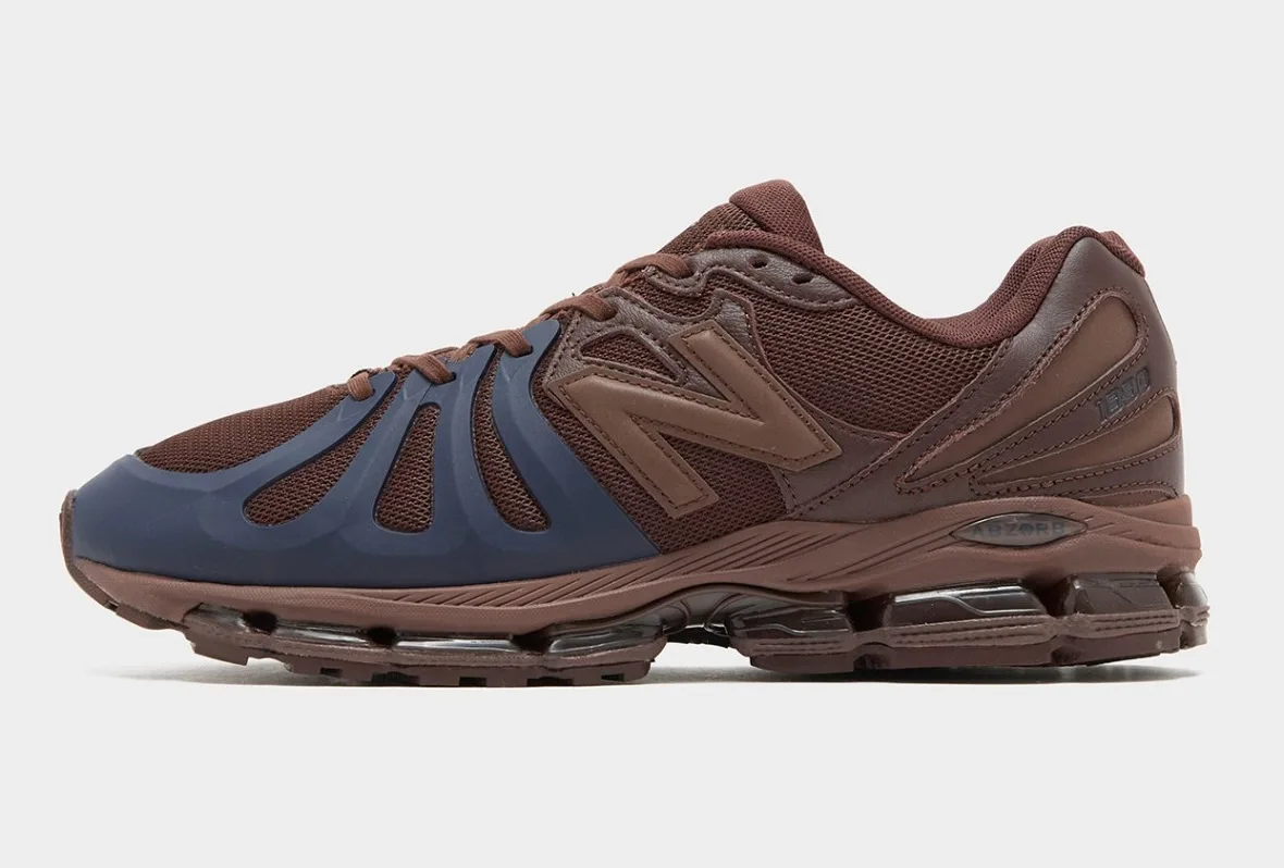 Lateral view of brown sneaker with navy toe cage, tan N logo and clear ABZORB heel section, Brown/Navy