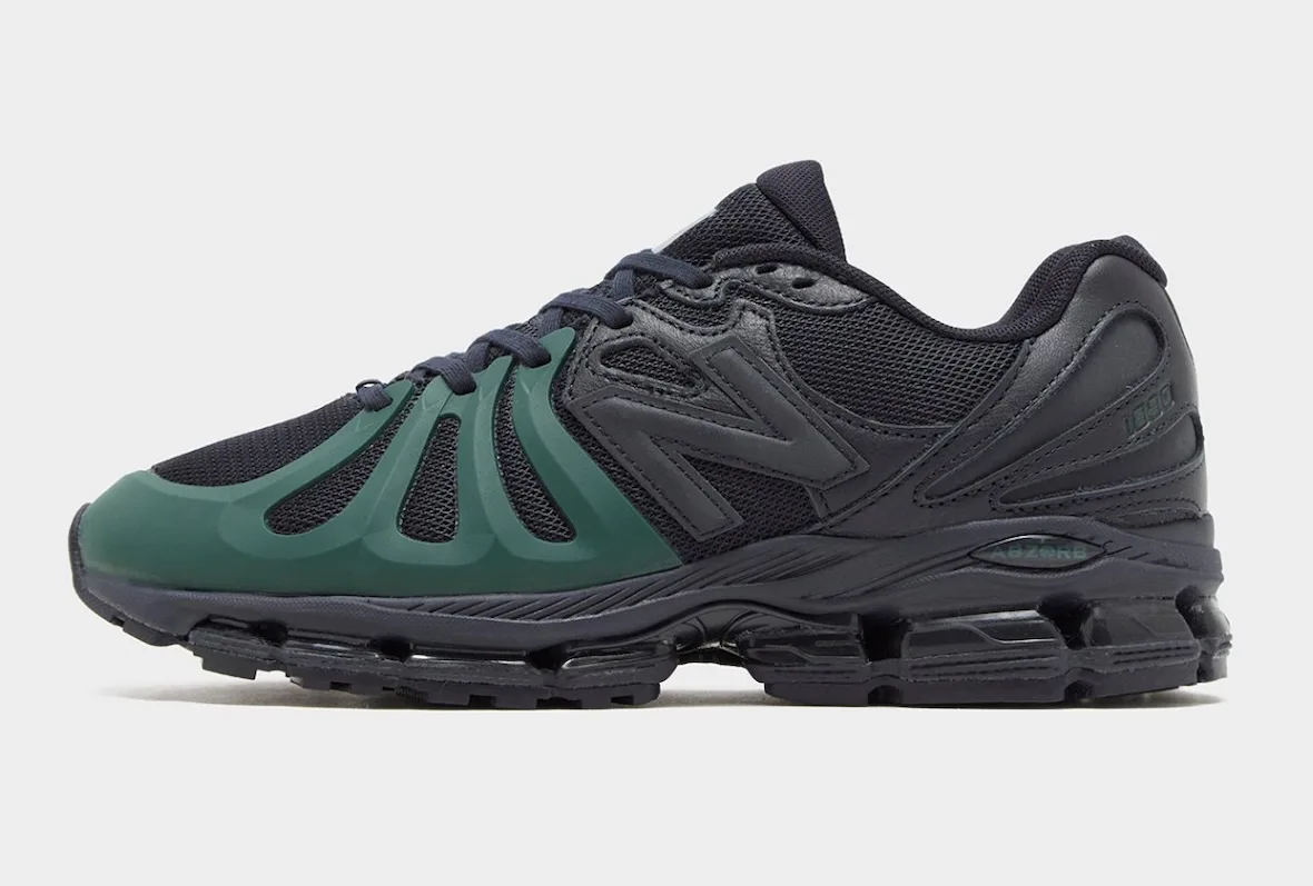 Lateral view of black sneaker with green toe cage, dark mesh and ABZORB midsole on plain grey background, Brown/Navy