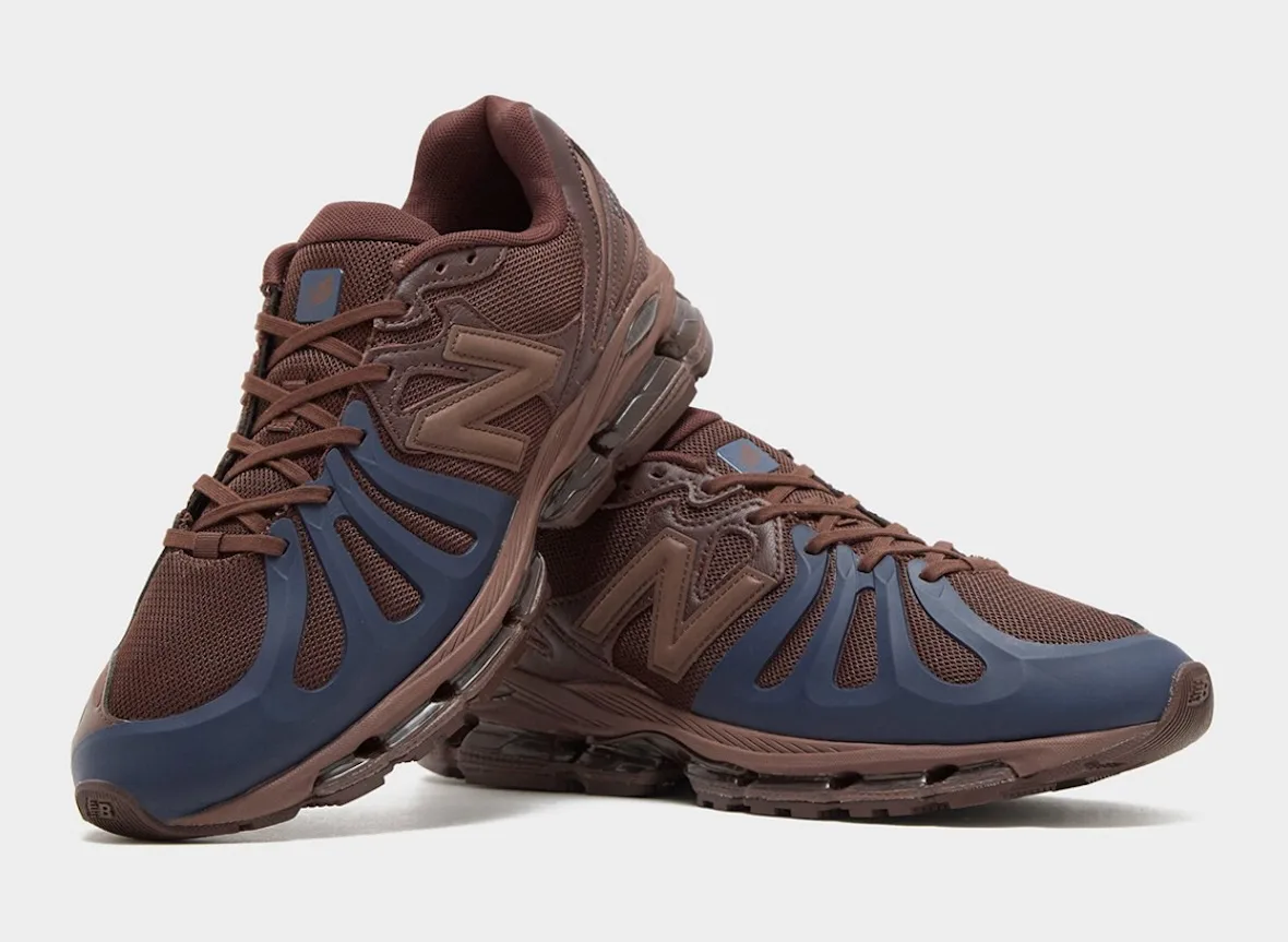 Stacked pair of brown sneakers with navy toe overlays and tan N logos, viewed from the front, Brown/Navy