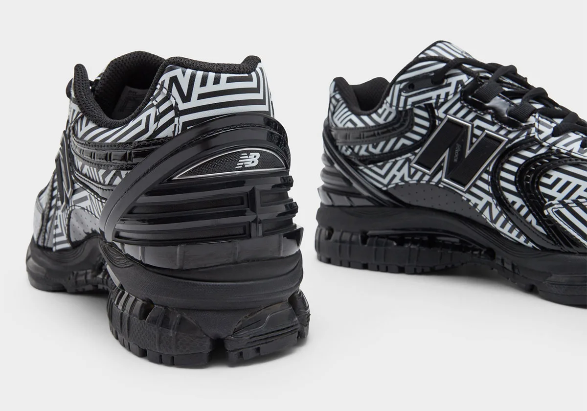Heel view of one shoe with New Balance logo on black heel clip and maze print collar, Dazzle Camo