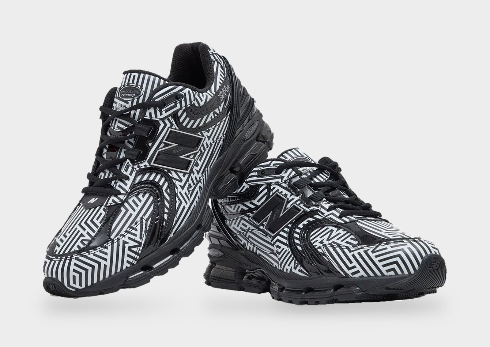 Pair angled view, one shoe resting on the other, black and white maze-line print with black, New Balance 1954R “Dazzle Camo”