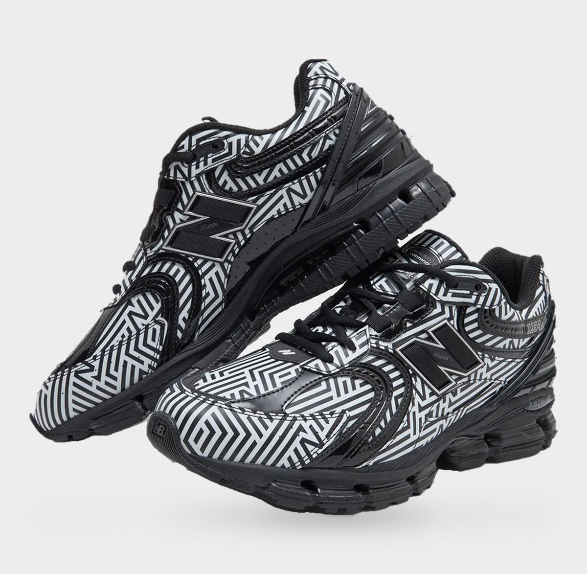 Pair angled from the toe, black and white maze print, black N logos and glossy overlays, Dazzle Camo