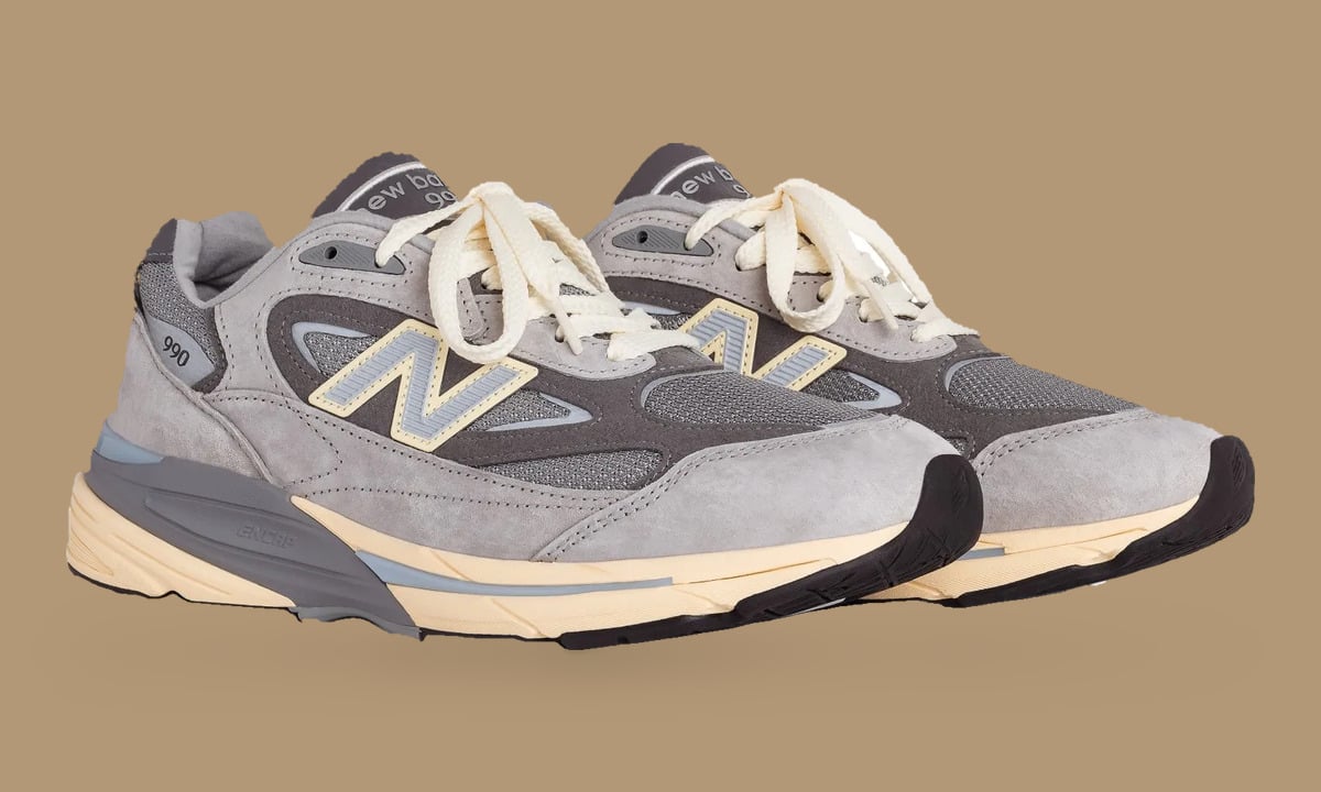 Pair from the front, grey suede, cream laces and N logos on tan background, Kool Grey
