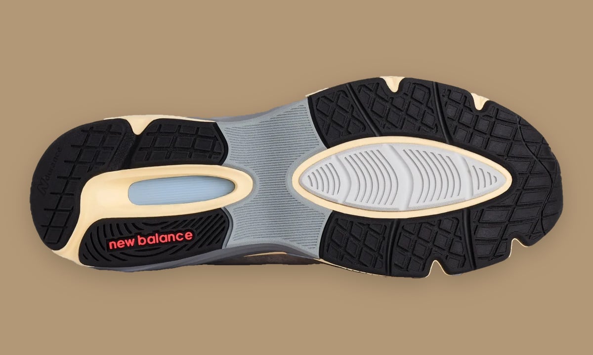 Outsole with black rubber lugs, grey shank and red new balance logo, Kool Grey