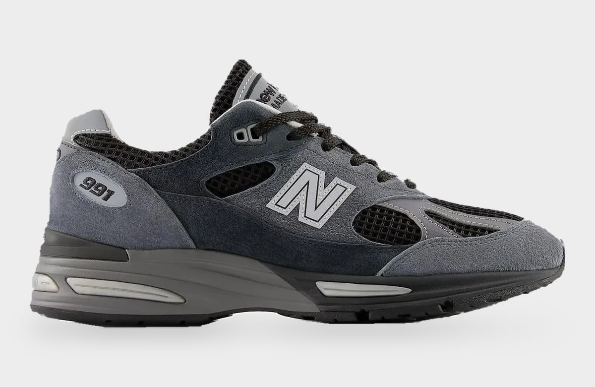 Lateral view with grey N logo, 991 oval on heel, black mesh panels and grey suede, Turbulence/India Ink