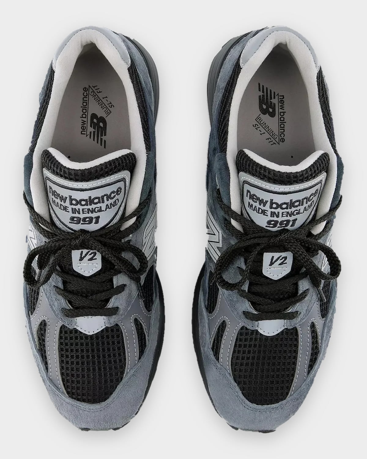 Top-down view of pair, black laces, grey tongue labels reading made in England 991 and V2, Turbulence/India Ink