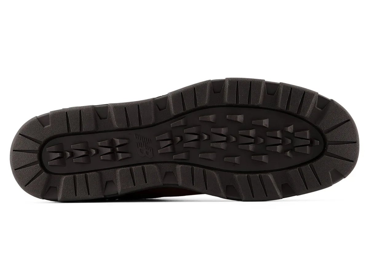 Outsole view in dark brown with deep lugs, tread pods and a central NB logo, Moorland Textures