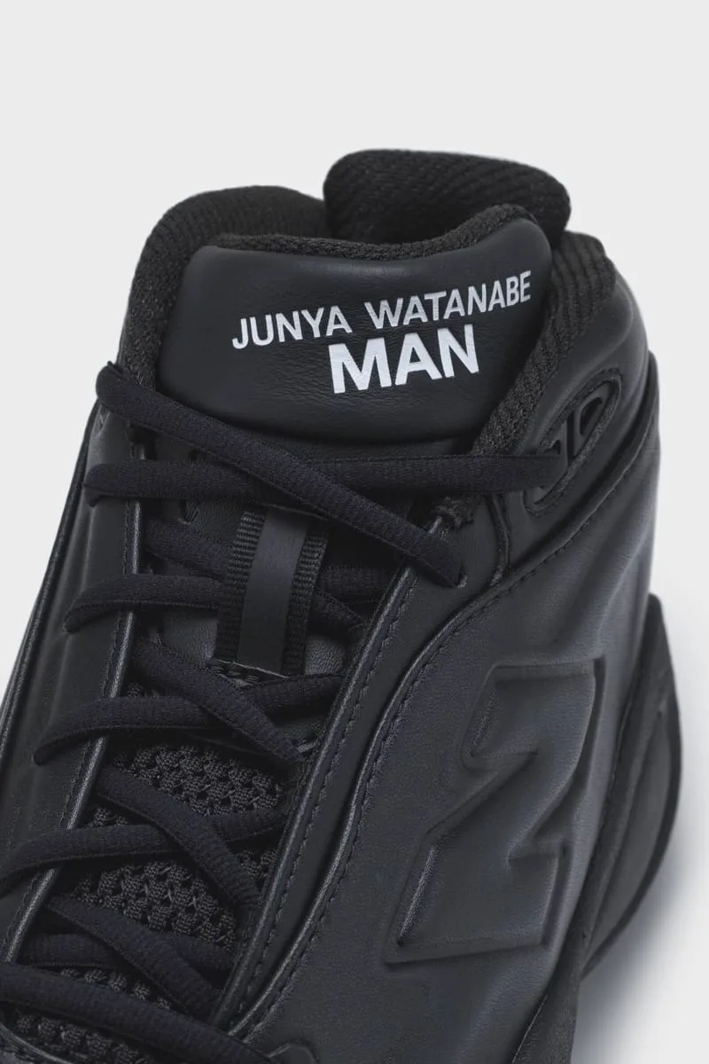 Close-up of a black leather tongue printed Junya Watanabe MAN, with black laces, mesh and a raised N, Watanabe MAN P400