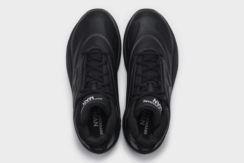 Top-down view of an all-black pair with black laces and white Junya Watanabe MAN text inside the collars, Watanabe MAN P400