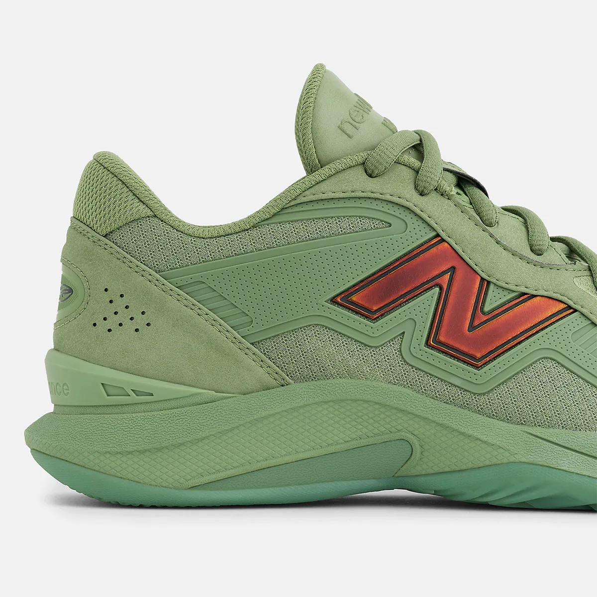 Detail of green heel and midfoot with red-orange N logo, perforated suede heel and mint sole, Balance Kawhi 5