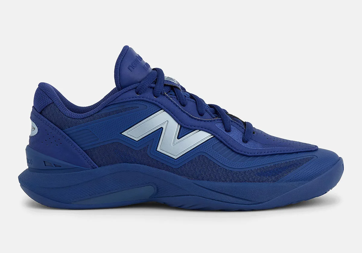 Lateral view of all-blue low-top with pale silver-blue N logo and mesh panels, Balance Kawhi 5