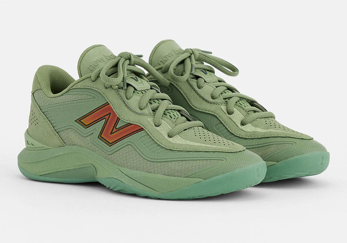Three-quarter view of green pair with red-orange N logo, suede heel and mint translucent outsole, Balance Kawhi 5